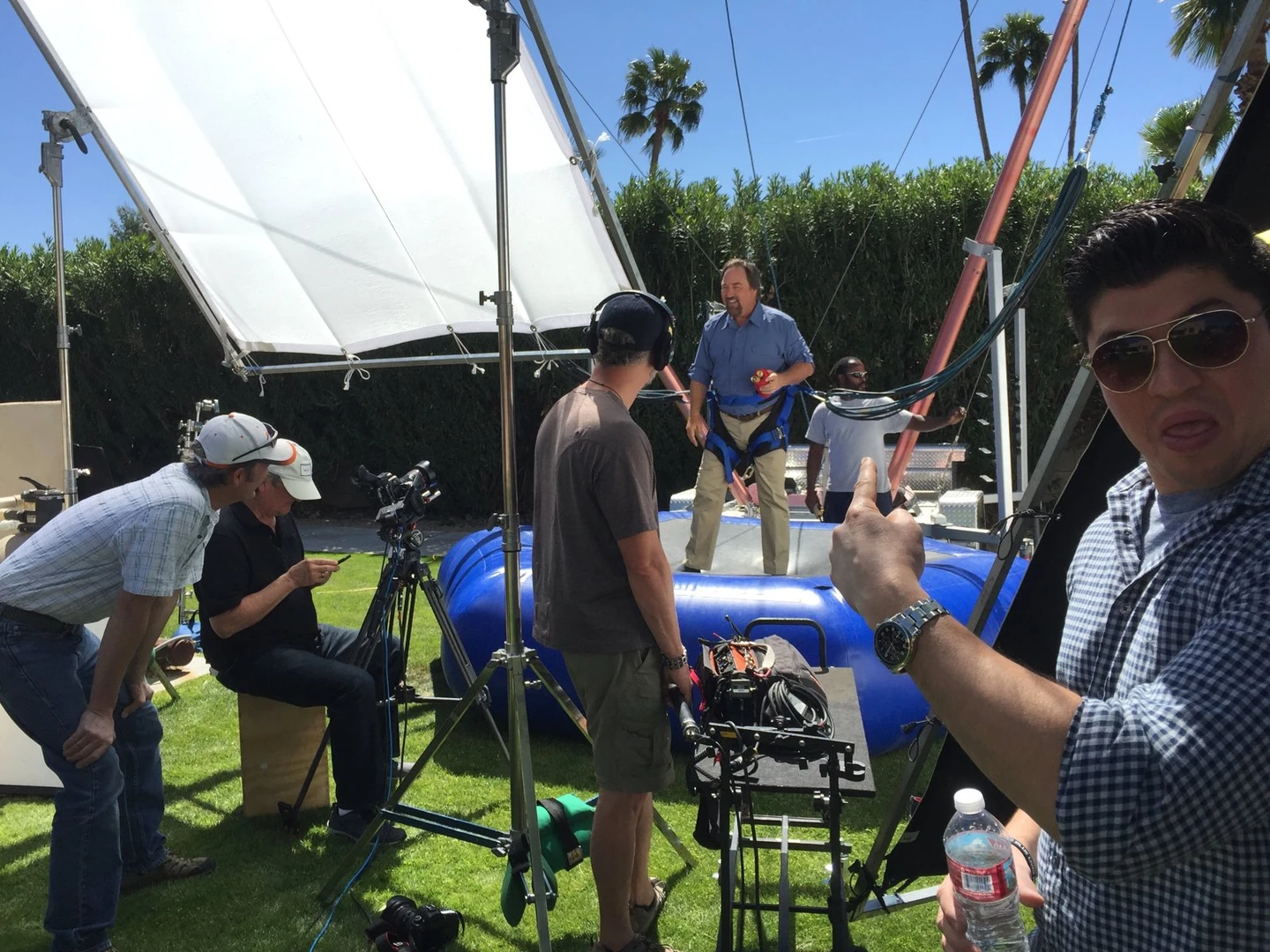 Crew members preparing an outdoor demonstration with camera and lighting equipment